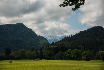 clouds over the snow peaked mountains