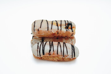 Eclairs glazed. Chocolate eclairs isolated on white background