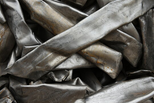 Twisted crushed compressed stainless steel pipes, scrap metal recycling