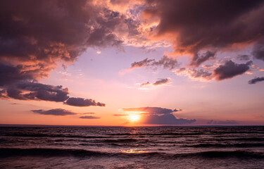 Sunset sky over sea waves.