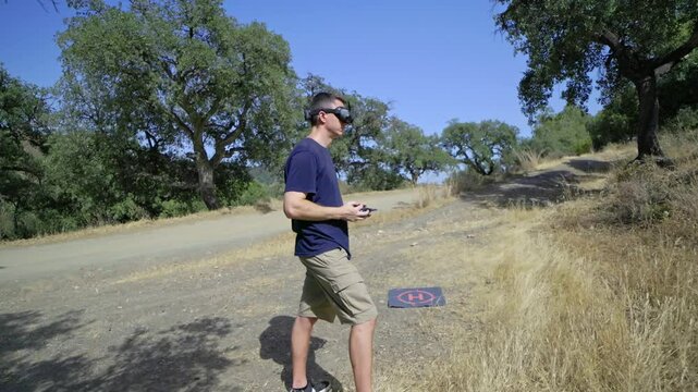 FPV Drone Pilot Actively Controlling a Drone in a Beautiful Outdoor Environment, Enjoying the Experience