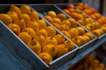 Lemons and oranges. Yellow and orange. Supermarket counter. Thanksgiving day. Tropical fruits. Vegetarian food. Strengthening immunity. Natural vitamins against colds and flu. Healthy food.