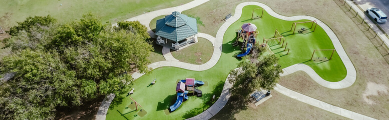 Panorama view residential neighborhood parked car on street near playground artificial turf,...