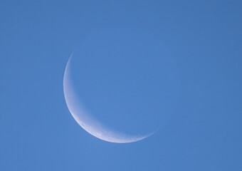 The waning crescent moon glowing in the morning sky over Ottawa, Canada September 28, 2024