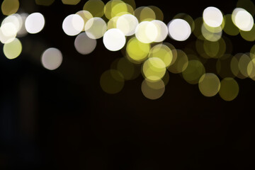 Abstract Bokeh Background with Glowing Yellow and White Lights on Dark Backdrop