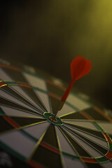 Bullseye Dart on Target Board in Low Light with Dark Background