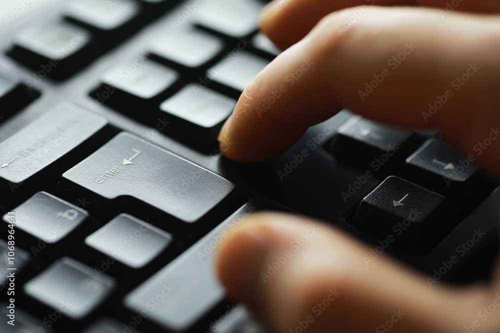 Poster close-up of fingers typing on a black computer keyboard for office and technology