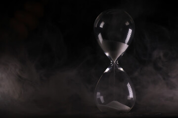 Timeless Elegance of a Sand Hourglass with Mist in Background