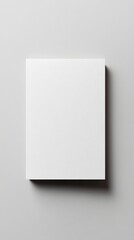 Naklejka premium Minimalist white rectangular card or book cover on light gray background, casting subtle shadow. Clean, modern design perfect for mockups or branding.