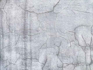 Cracked concrete wall with visible texture and gray tones