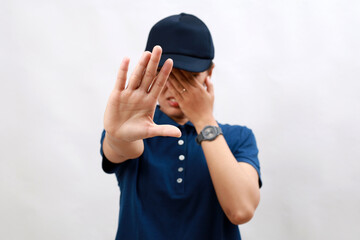 Young hispanic woman courier wearing delivery uniform and cap covering eyes with hands and doing stop gesture with sad and fear expression. embarrassed and negative concept.