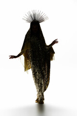 A radiant African American goddess captures attention in a dazzling golden dress, embodying elegance and strength.