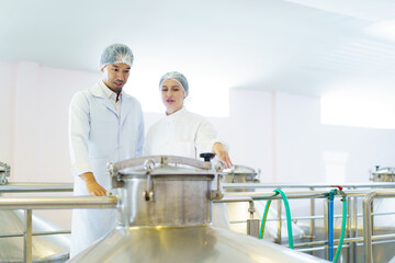 Quality control officer are examining in beverage manufacturing factory.