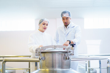 Quality control officer are examining in beverage manufacturing factory.