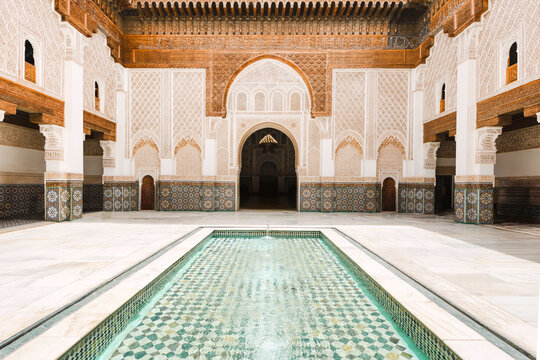 Ben youssef madrasa courtyard with intricate tile mosaics and water pool in marrakech, morocco, traditional islamic architecture design in an historic and famous destination, cultural landmark