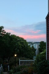 Tranquil Evening Sky with Pink Clouds over Residential Neighborhood