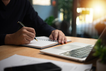 Person taking notes with pen on notebook, planning, organization, or learning. Ideal for business,...