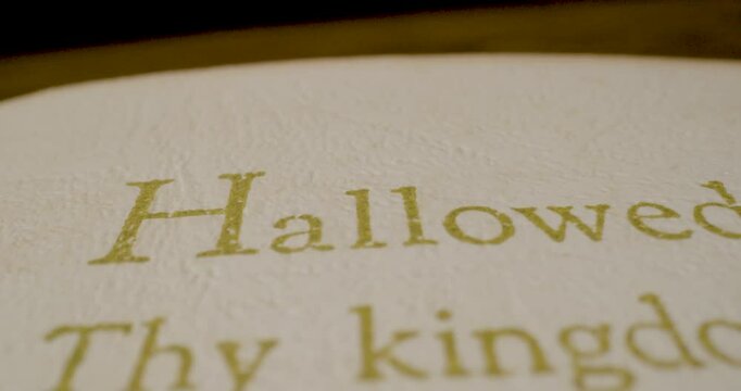 Holy Bible Beige Cover Hallowed Be Thy Name Text Pan Right Macro