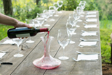 wine glasses on a wooden table outdoor in the countryside