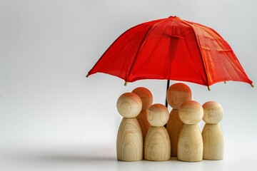 Family Under a Red Umbrella with Wooden Figurines