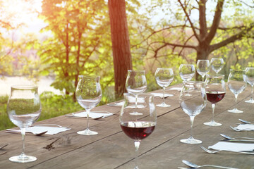 wine glasses on a wooden table in the countryside