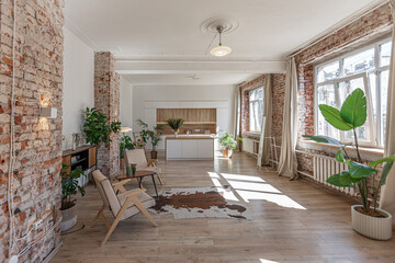Fototapeta premium Bright and spacious living area featuring modern furniture and natural light in a stylish apartment in soft warm colors