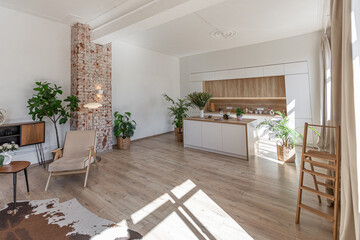 Bright and spacious living area featuring modern furniture and natural light in a stylish apartment in soft warm colors