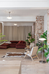 Bright and spacious living area featuring modern furniture and natural light in a stylish apartment in soft warm colors