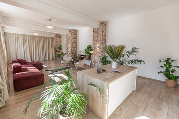 Bright and spacious living area featuring modern furniture and natural light in a stylish apartment in soft warm colors