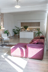 Bright and spacious living area featuring modern furniture and natural light in a stylish apartment in soft warm colors