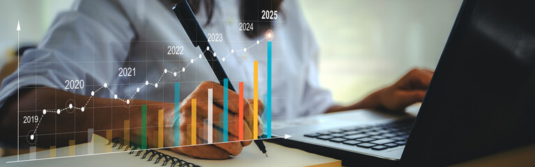 2025 Businesswoman analyzing company financial balance sheet working with digital virtual graphics...
