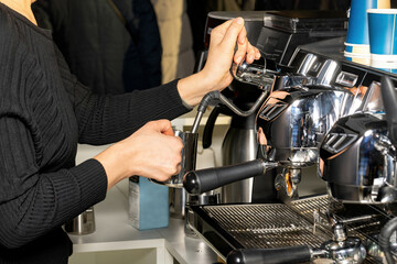 Crafting the perfect espresso in a bustling café during the morning rush hour.