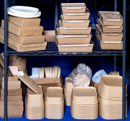 Neatly organized eco-friendly food packaging displayed in storage shelves for sustainable dining.