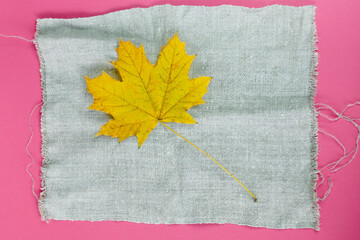 Yellow maple leaf on linen napkin