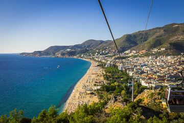 Alanya castle top view on the mountain with coast ferry boat on blue sea . Beautiful cleopatra...