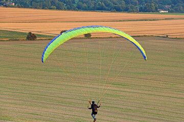 Paraglider flying from a hill	