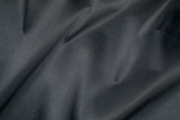 Black fabric features a smooth, soft texture with gentle draping and a subtle sheen, perfect for...