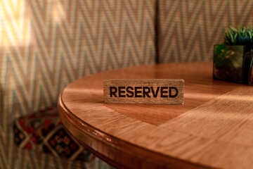A sign that the table is reserved in the restaurant. Copy space.