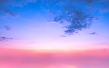 Sundown cloudscape. Fluffy clouds in the sunset of dark blue - pink - orange sky. Dreamy evening. Beautiful daybreak