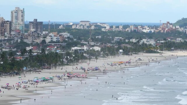 Aerial view of Enseada Beach, a beautiful beach with a view of the shore, of the sea and the Guaruja city. Guaruja - SP, Brazil. Time lapse video.