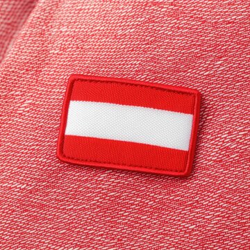 CloseUp of Monacos Flag Patch on Luxurious Red and White Fabric. Monaco National Day
