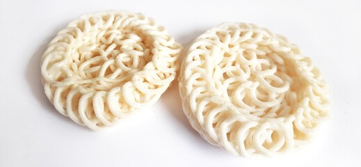 White noodle crackers or kerupuk putih or kerupuk warung made from tapioca flour, snack food from Indonesia isolated on white background