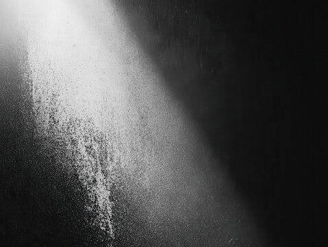 black and white grainy gradient background with an illuminated spot creating a dramatic contrast, perfect for textual overlays and minimalist design aesthetics