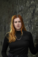 Naklejka premium Studio portrait of a young beautiful red-haired girl.