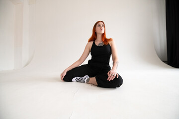 Fototapeta premium Studio portrait of a young beautiful red-haired girl.