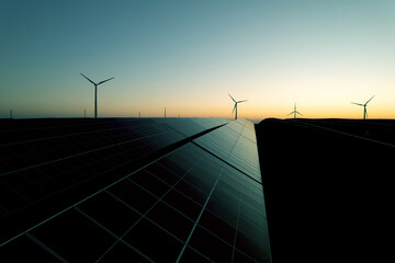 Windmill turbines generating green energy electric.Solar panels park and wind turbines at...