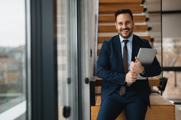 Portrait of handsome businessman working at office