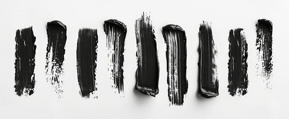 Mascara brush stroke swatch set isolated on white background. Smears of make-up cosmetic eyelash mascara, top view.