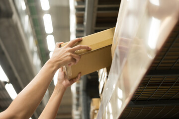 Closeup hands picking up products box paper on shelf. Customers picking up items on shelves....
