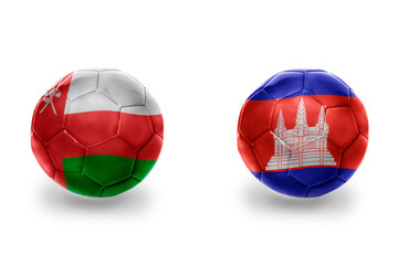 Fototapeta premium football balls with national flags of cambodia and oman ,soccer teams. on the white background.